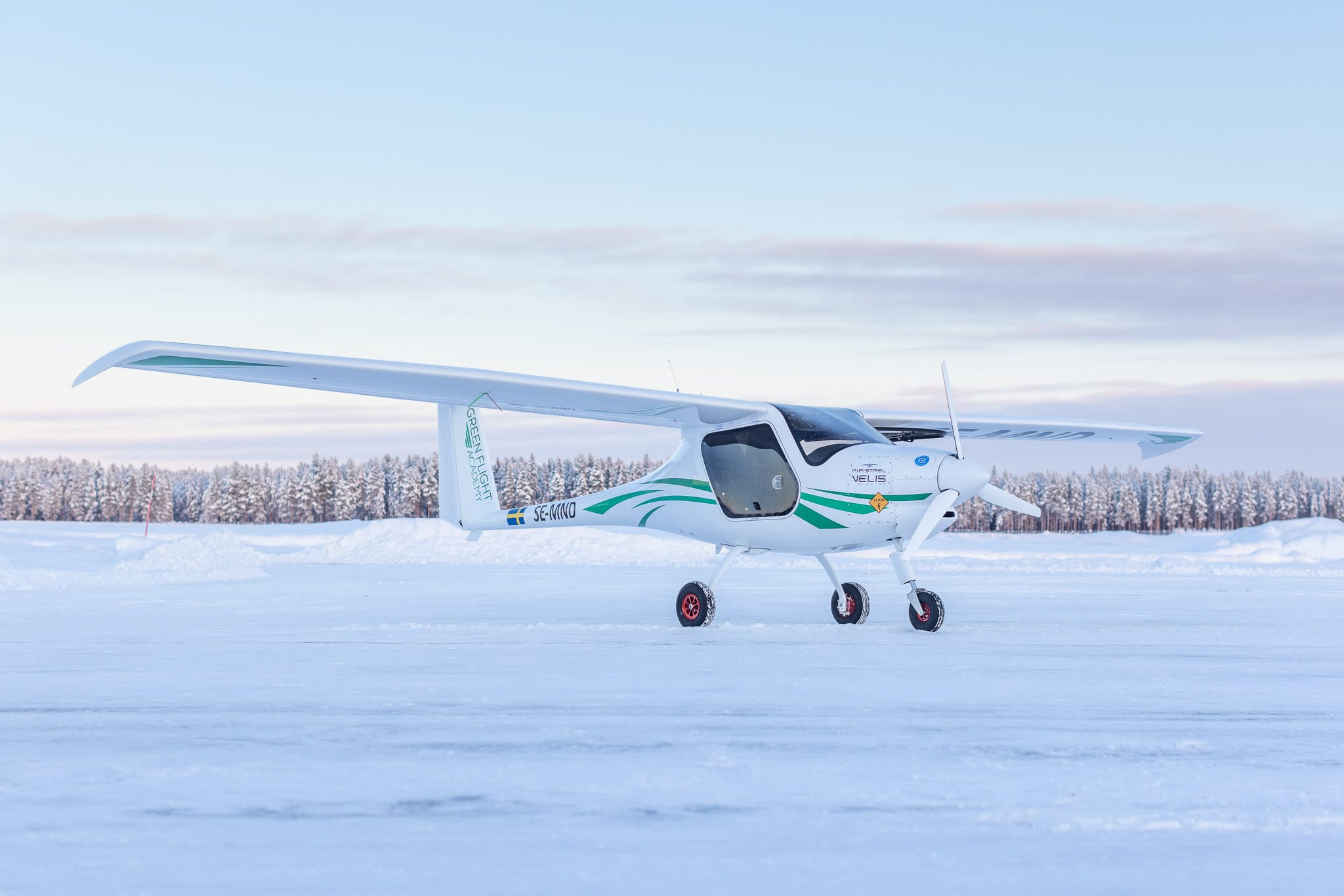 Small airplane on snow-covered ground.