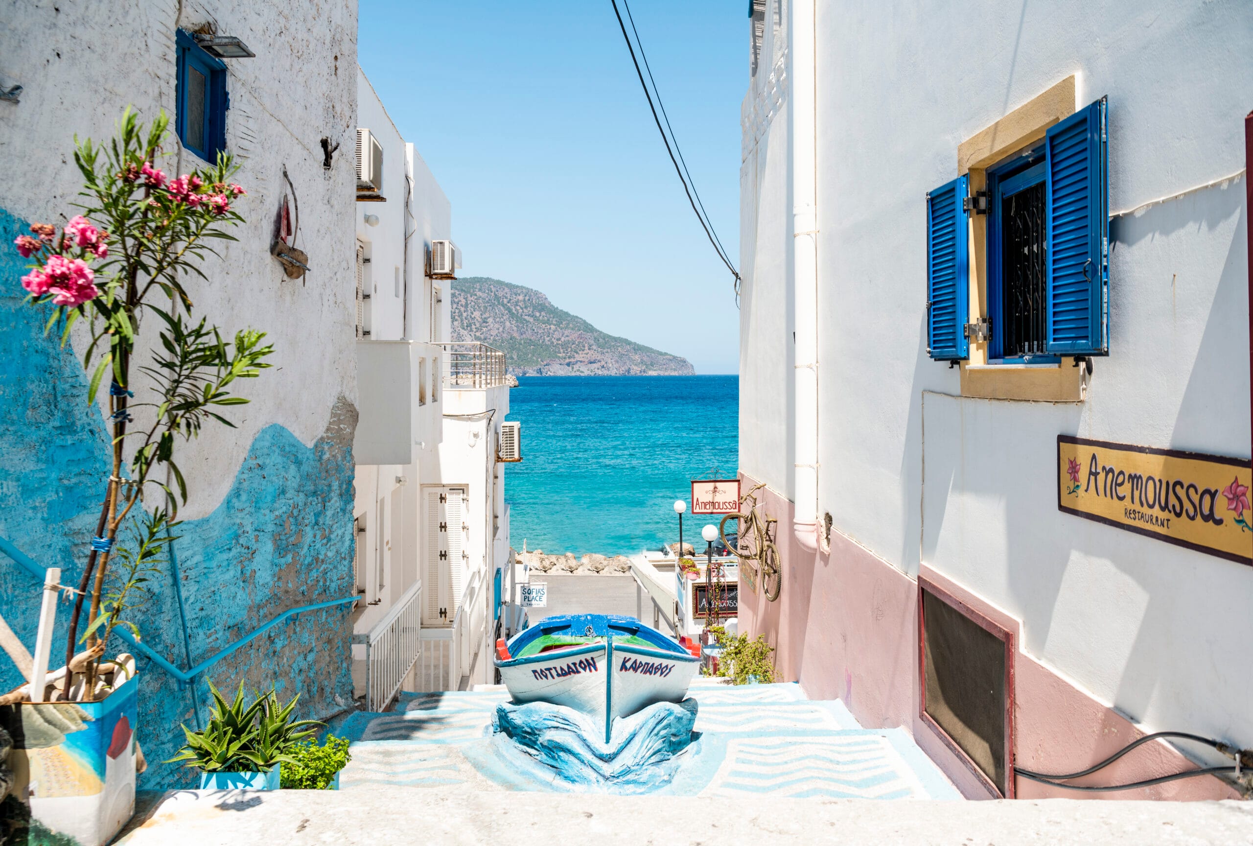 Beach view between white houses and flowers