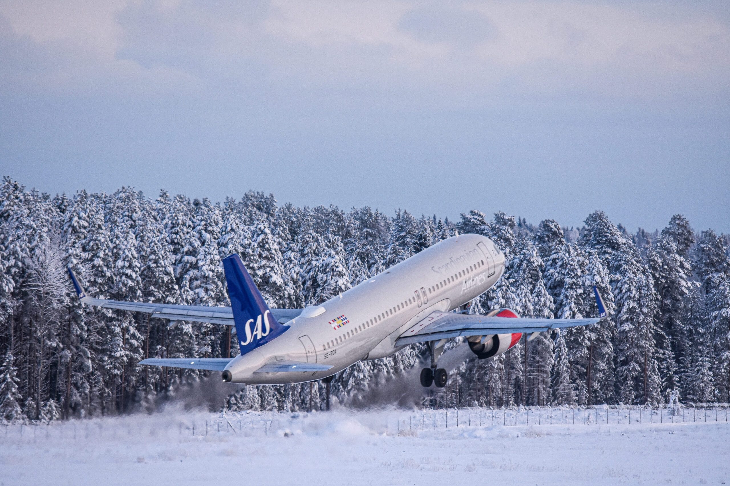 Airplane taking off from snow-covered runway